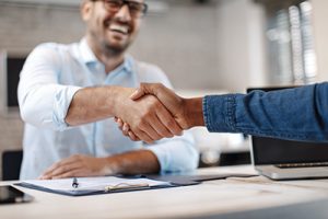 Web design LBI professional shaking hands with a client over a desk